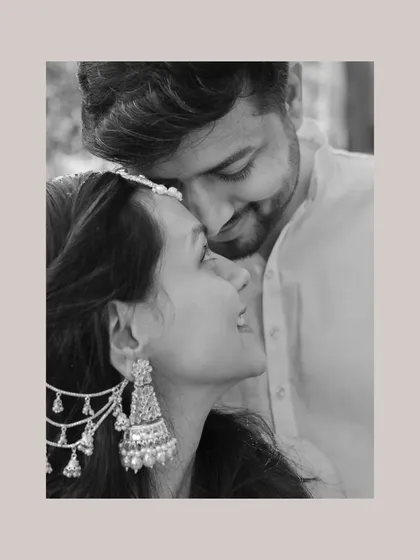 A beautiful black and white close-up, focusing on the tender and affectionate connection between the couple during their Haldi.