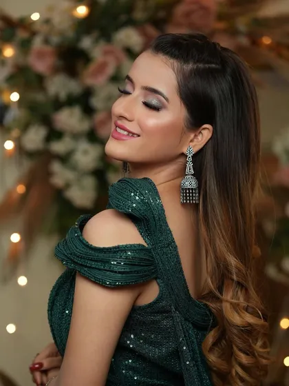 The smile of someone who knows she looks amazing. The soft pink lip and glowing skin provide a beautiful contrast to the dramatic eye makeup.