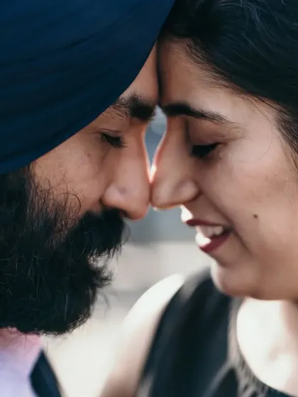 An intimate close-up of a couple, nose-to-nose, sharing a quiet moment. This type of shot captures the deep, unspoken connection between two people.