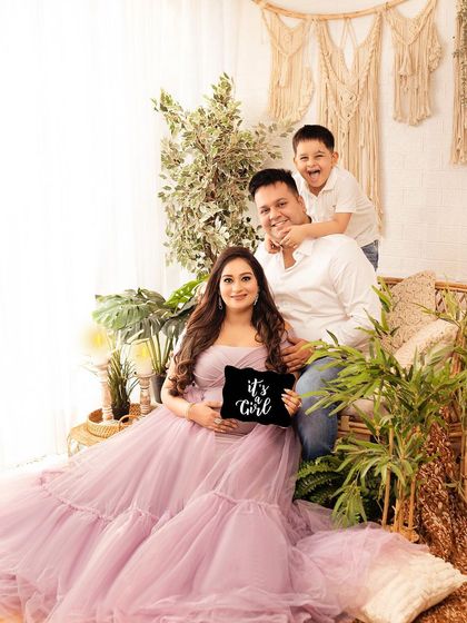 A fun and candid family moment during a maternity shoot. The older brother's playful energy brings so much life to the photograph.