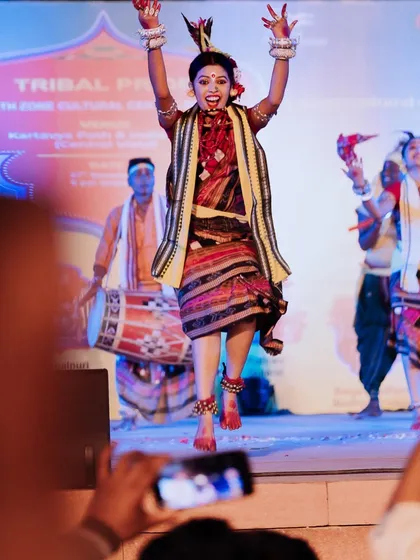 A dancer leaps into the air with infectious energy during a cultural celebration at Kartavya Path. Freezing these peak action moments makes for incredibly dynamic event photos.