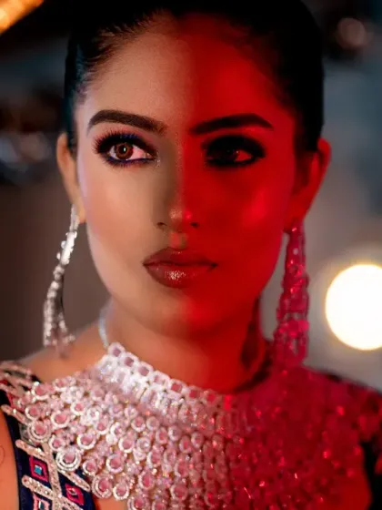 A creative portrait using a mirror and split lighting. The red light on one side creates a stunning, edgy, and symmetrical image.