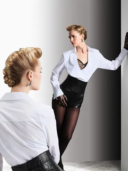 We designed this powerful, vintage-inspired updo for the woman who stands out. The sculpted hair and bold styling create a look of undeniable confidence and timeless glamour.