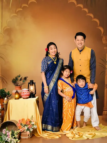 A vibrant family portrait celebrating cultural heritage. This Japanese family chose to wear traditional Indian attire against one of our painted backdrops, showing how we can create unique, themed sessions that are meaningful to you.