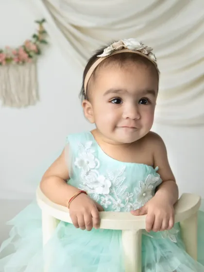 A close-up portrait with a gentle, knowing smile. These are the moments that truly capture the soul of your little one.