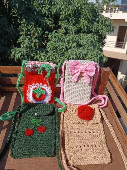 A collection of my custom phone sling bags. This image features strawberry, bow, cherry, and rose designs, perfect for a themed retail collection.