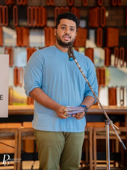 A poet holding his notebook while performing at our Starbucks meetup. This image captures the classic essence of a writer sharing his craft with an attentive audience.