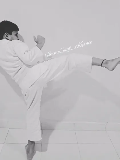 "You can be the greatest, you can be the best!" A young white belt student practicing his kick, full of potential and determination.