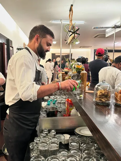Our bartender crafts a refreshing drink at a bespoke bar setup. This behind the scenes shot from the 'Fabulous Lives of Bollywood Wives' event showcases our full service capabilities, including professional mixology.