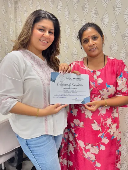 A proud moment for Sanjana as she receives her certificate of completion. She is now equipped to add professional nail services to her makeup artistry business.