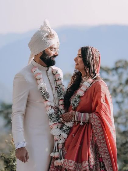 A stunning portrait of the couple against a backdrop of mountains, taken on their wedding day.