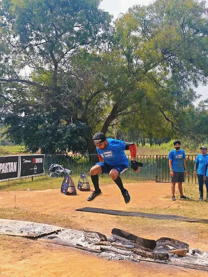 An action shot from the Spartan Race, showing one of our members clearing an obstacle with power. Our training focuses on building the functional strength needed for these explosive movements.