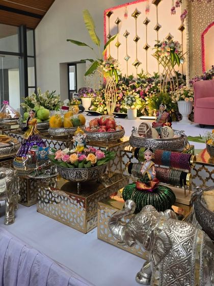 A side view of a long offering table, showing the variety of silver props and tiered stands I use.