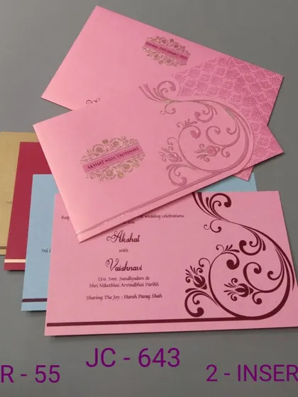 This pink invitation features a simple scroll design and comes with inserts in various colors. It's a budget-friendly and cheerful option for your wedding.
