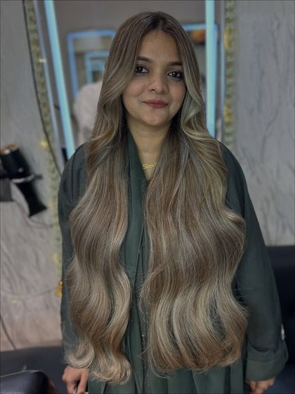 The happy client with her new Icy Ash blonde hair. The color brightens her complexion and looks absolutely stunning.