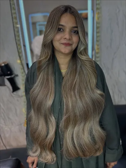 A full view of the client with her new icy ash blonde hair. She looks absolutely radiant, and this color is a true showstopper for the wedding season.