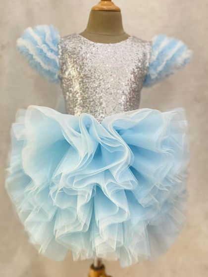 Our ultimate "Frozen" dress. This design features a silver sequin bodice and a voluminous ruffled blue tulle skirt, capturing the icy magic of Elsa's gown.