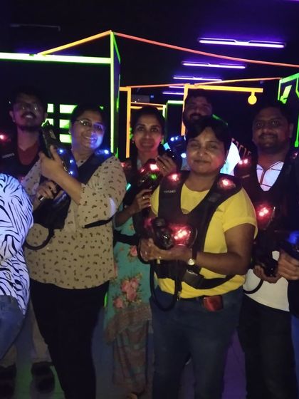 Friends and colleagues ready for a team-building laser tag session.