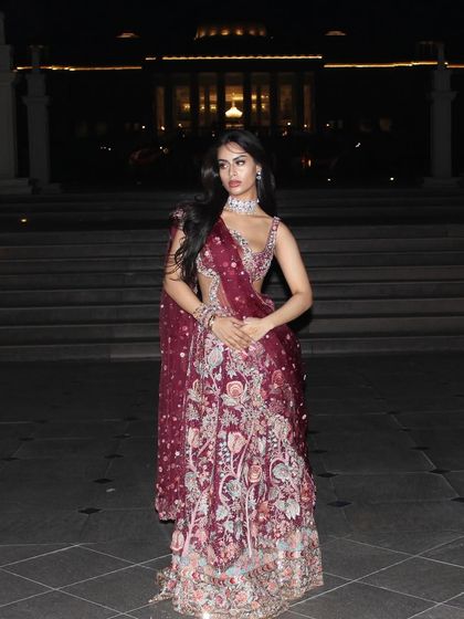 A magnificent shot of Nysa in a deep maroon, heavily embroidered lehenga, looking absolutely regal for a grand wedding night.