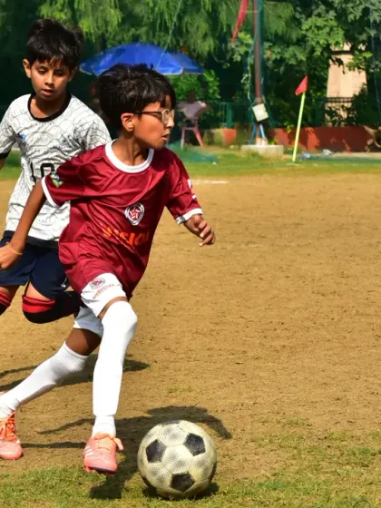 A player dribbles past an opponent, showcasing the agility and skill honed during our training sessions.