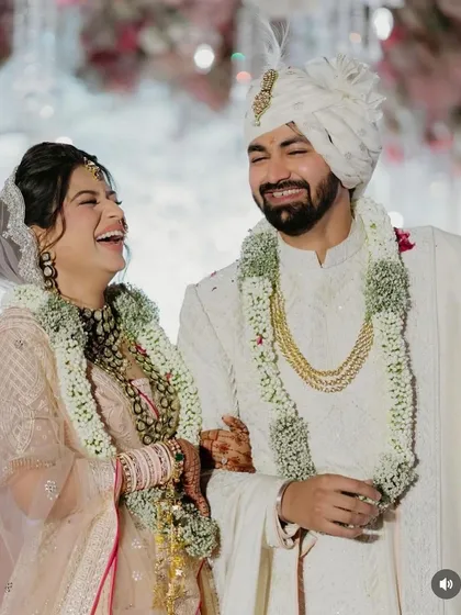 A candid laugh from the bride and groom. Her simple and elegant half updo stays in place throughout the ceremony, allowing her to live in the moment.