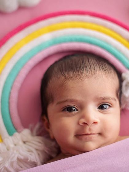 Look at this little rainbow baby looking right at me! Not all babies sleep through their session, and capturing their bright, curious eyes is just as precious.