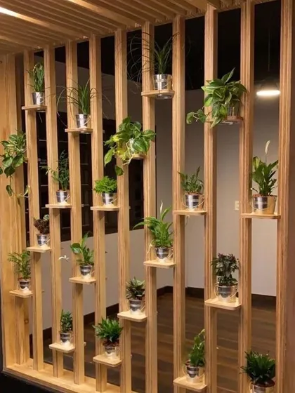 This wooden structure acts as both a room partition and a vertical garden. The open slats maintain a sense of space, while the built-in shelves are perfect for displaying a collection of small potted plants.