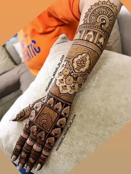 The completed back-of-hand bridal design, featuring a mix of geometric checks, floral patterns, and a beautiful peacock mandala at the top.