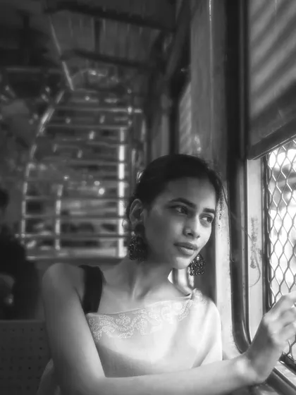 Black and white brings a timeless feel to this train portrait. It strips away the color to focus on the emotion and the play of light through the window.