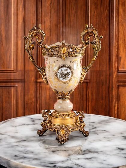 This grand Victorian-style urn features ornate handles and a classic shape, finished with delicate gold patterns. It's a truly magnificent showpiece for a formal living room or entryway.