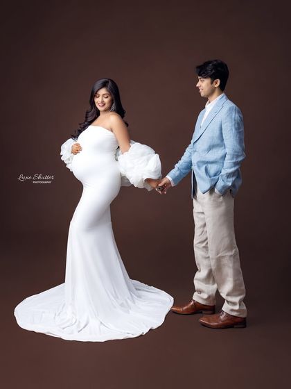 Walking into the future together. This pose symbolizes the journey of parenthood that the couple is embarking on, hand in hand.