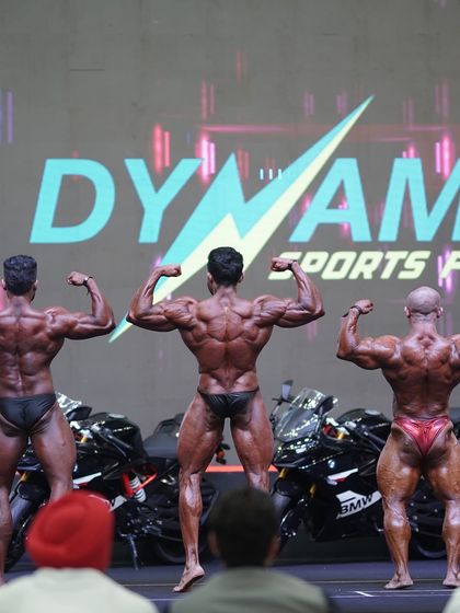 Rear double bicep pose on the championship stage. This is where you show the judges the width and thickness of your back.