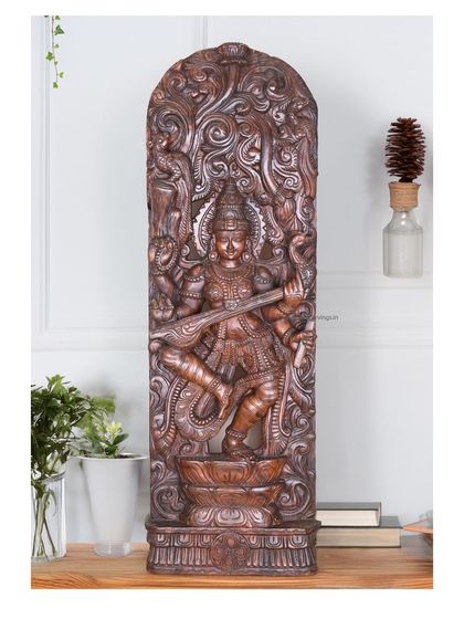 A 48-inch wall mount of Abhinaya Saraswathi, the dancing goddess of knowledge, finished in a deep brown. Her dynamic pose is captured with incredible detail.