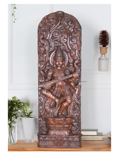 A 48-inch wall mount of Abhinaya Saraswathi, the goddess of arts, in a dancing pose. The intricate floral jali design and the dynamic posture make it a mesmerizing piece for any room dedicated to learning or creativity.