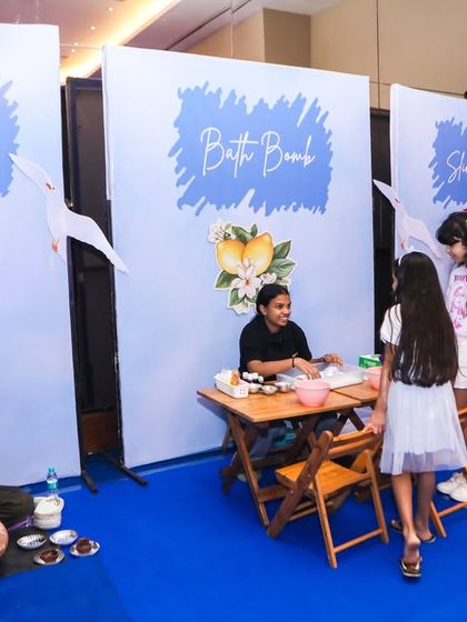 A wide view of the different art stations, including pottery, bath bomb making, and stone painting.