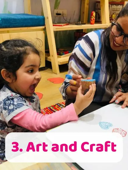 A young girl's face lights up with excitement as she uses a block stamp. This traditional Indian printing technique is a great way to introduce kids to patterns and design.