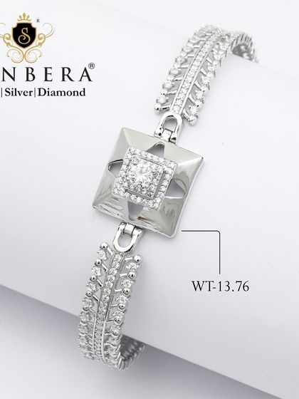 A bold and modern silver bracelet with a square, architectural charm. Weighing a substantial 13.76 grams, this piece is grace wrapped around your wrist.