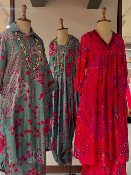 A full view of the summer floral collection, showcasing different styles from collared dresses to draped silhouettes.