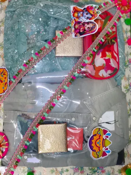A Holi gift set for a couple, containing outfits for both, along with small gift boxes.