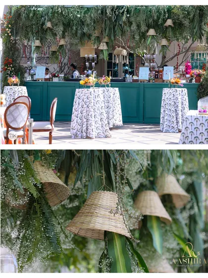 A bar designed to feel like a forest fantasy, with a lush canopy of hanging greens and woven basket lampshades over a striking teal counter.