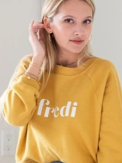 This is a perfect example of lifestyle photography. The model in a casual sweatshirt, captured in a natural, relaxed pose, helps customers connect with the brand's comfortable and effortless vibe.