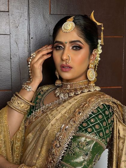 Embrace tradition with this exquisite gold-look temple jewellery set. Featuring a detailed choker, matching jhumkas, and an ornate maang tikka, this set is perfect for a classic bridal look.