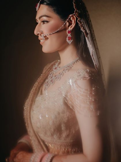 A soft, dreamy profile shot of Shreya. The gentle lighting and her happy expression capture her confidence and the modern elegance of her bridal style.