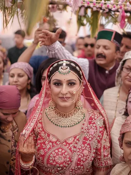 The bride's entry, surrounded by her family in traditional Himachali attire. A beautiful blend of emotion and culture.