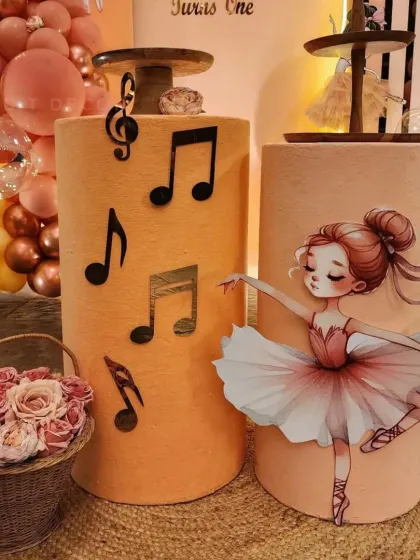 Themed props like these musical note stands and a graceful ballerina cutout add so much charm to the decor.