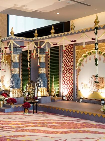 A full view of the grand entrance structure, designed to resemble a temple gopuram. This setup, placed in the hotel lobby, set the stage for the immersive experience to come, featuring detailed pillars, traditional motifs, and floral decorations.