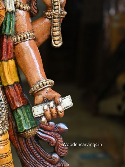 A detail of the 47-inch Lakshmi statue's hand holding scriptures, symbolizing knowledge and dharma.