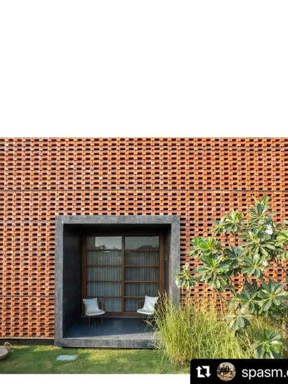 A small, shaded seating nook is carved out of the facade of the Ishtika house. We surrounded it with a lawn and carefully selected plants to make it feel like a private garden room.