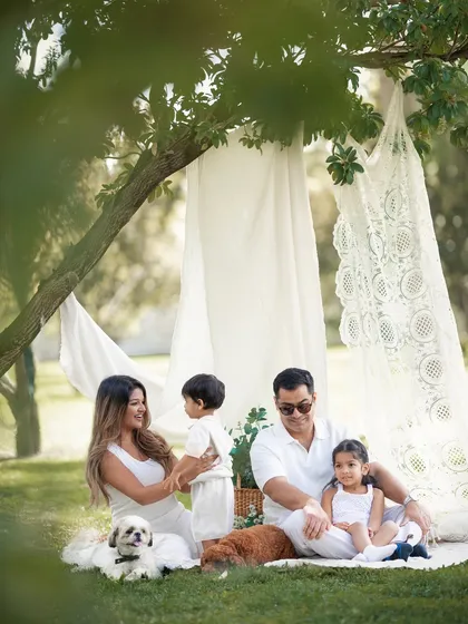 A relaxed, interactive moment during an outdoor family shoot. The family pets are free to be themselves, which results in the most natural and authentic photographs.