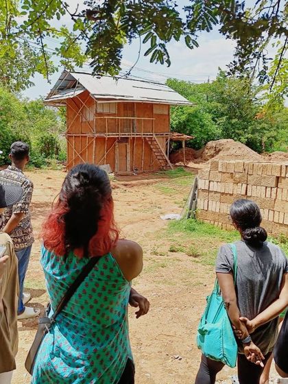 Our teams visiting a wattle-and-daub house under construction. These site visits are crucial for learning and sharing knowledge within the team.